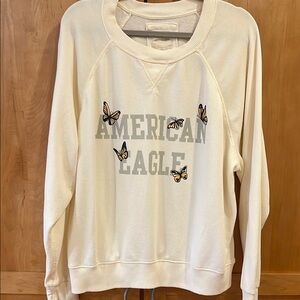 American Eagle Cream sweatshirt with American Eagle Logo and printed butterflies